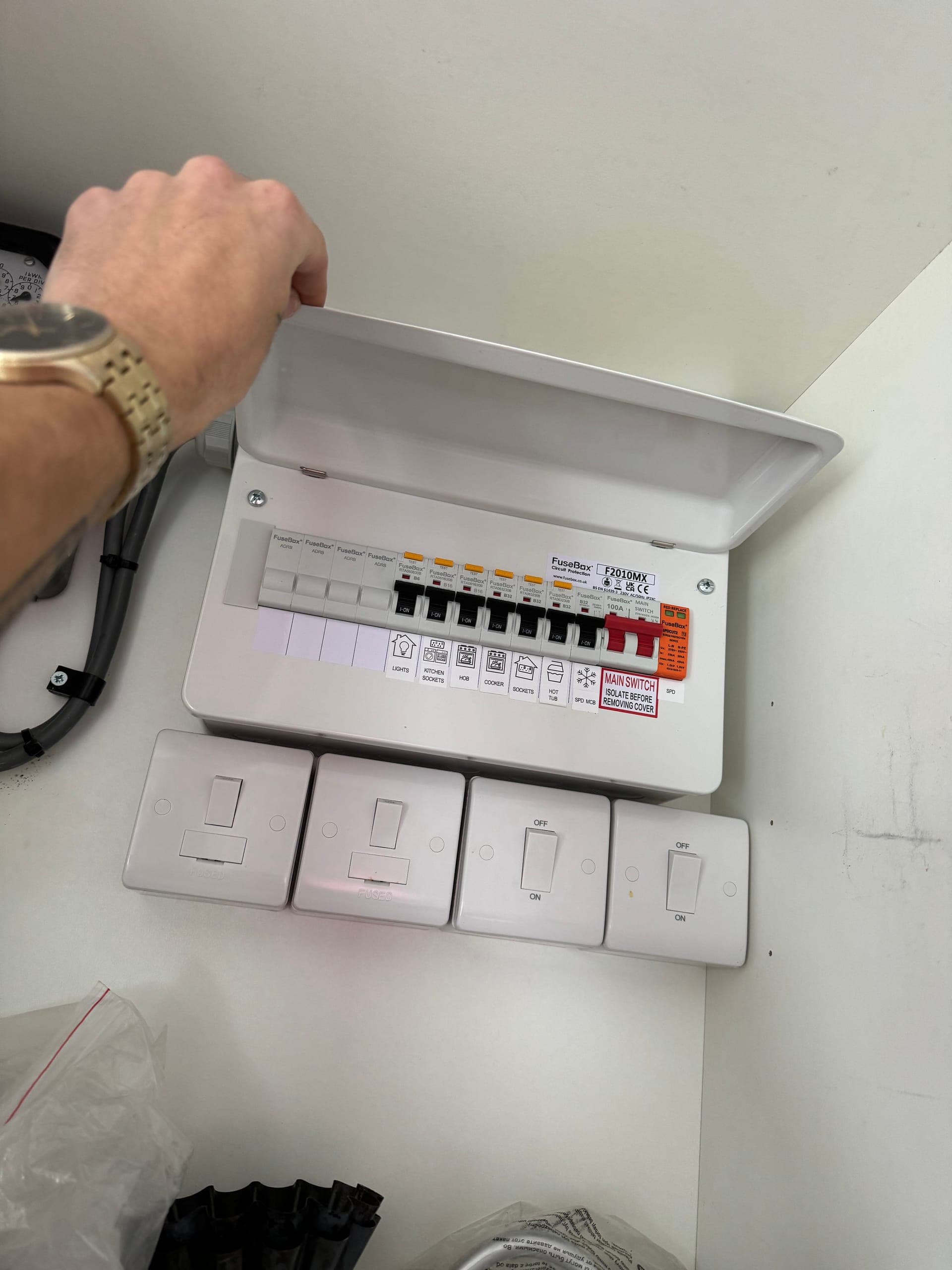 FuseBox consumer unit being labelled up on the bench before installation, with the switched spurs that go with it