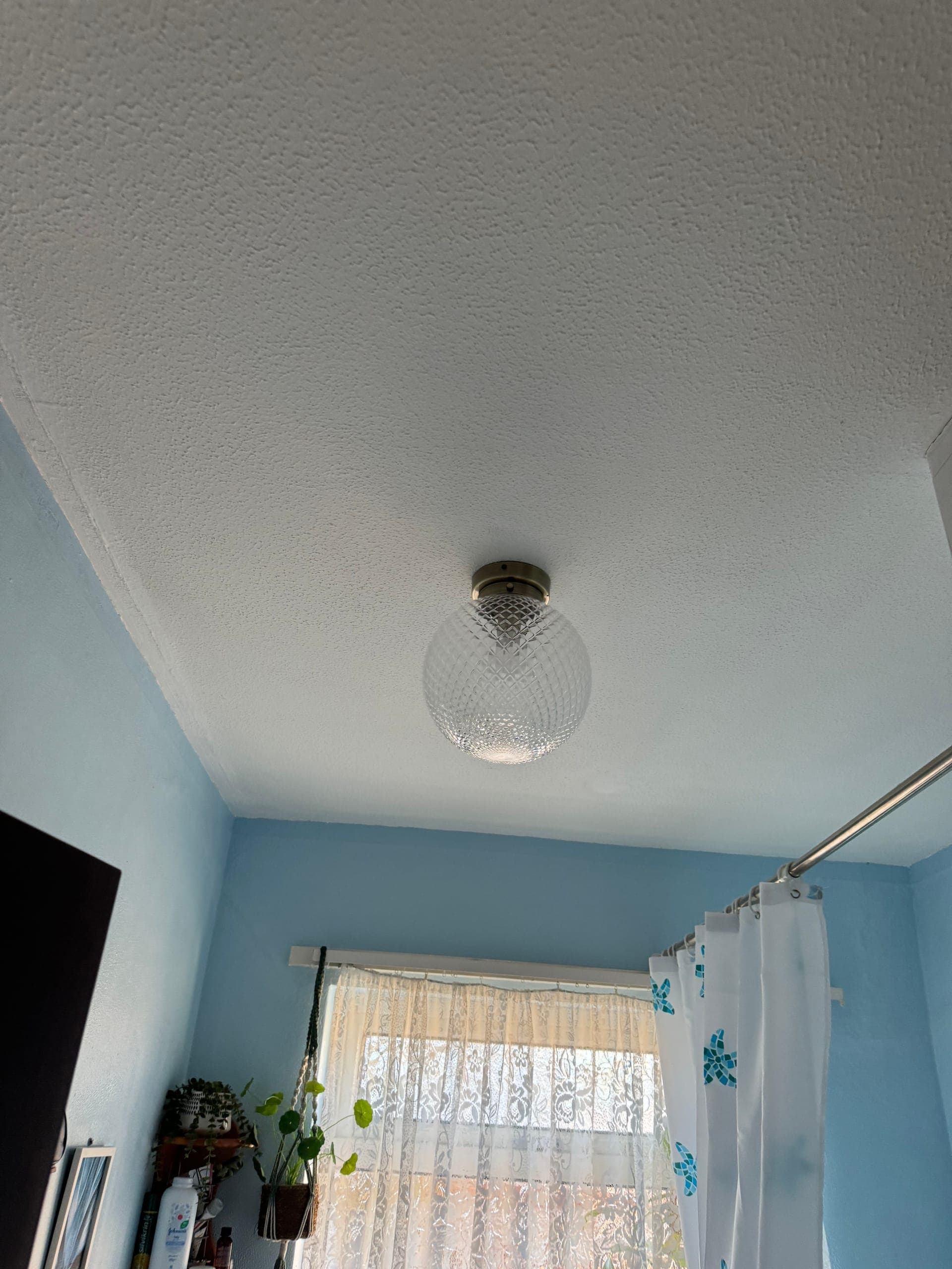 Decorative globe ceiling light fitted in a bathroom