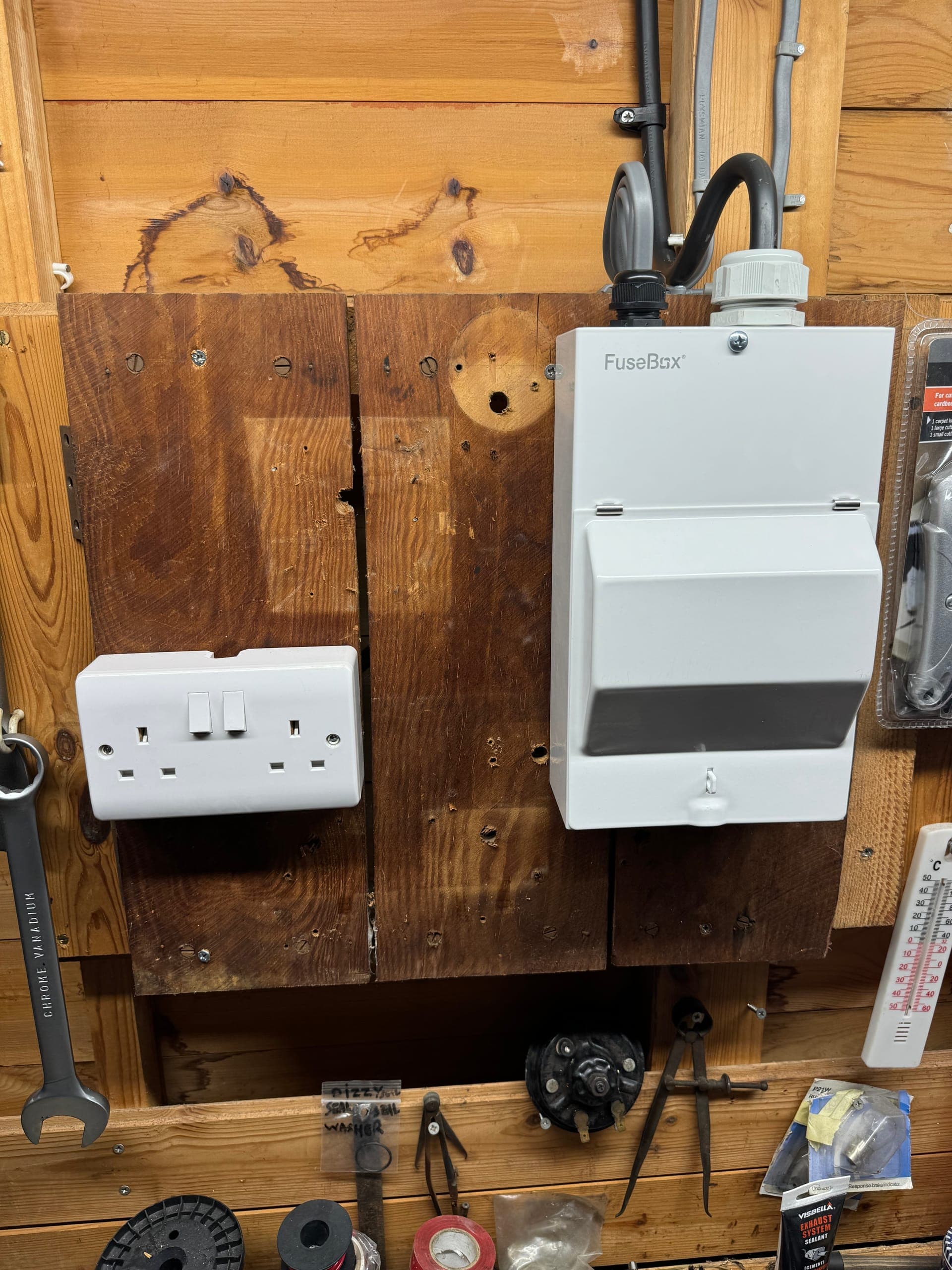 Twin socket and a compact consumer unit mounted together on a workshop backboard