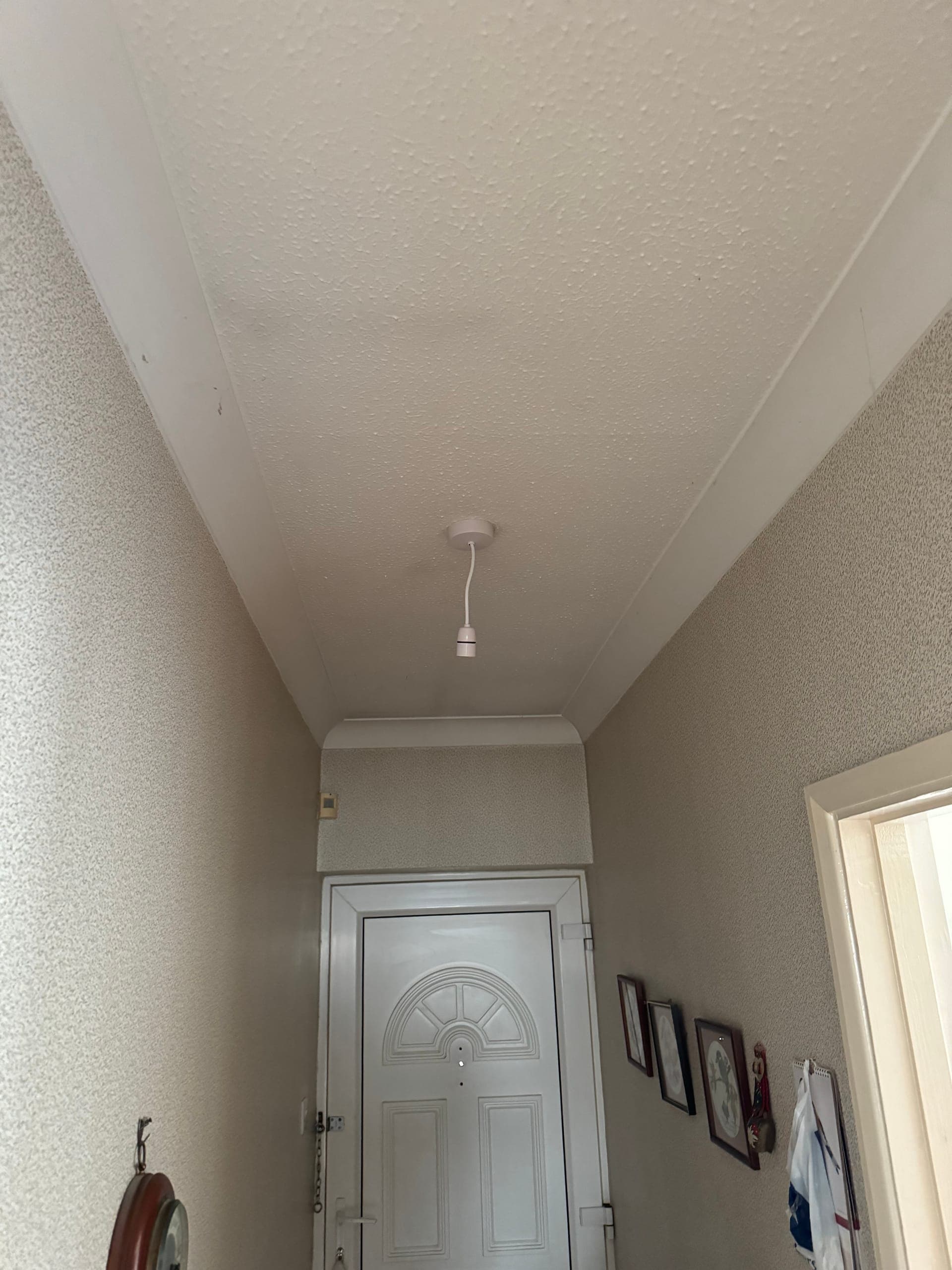 New pendant lampholder fitted to a hallway ceiling above the front door